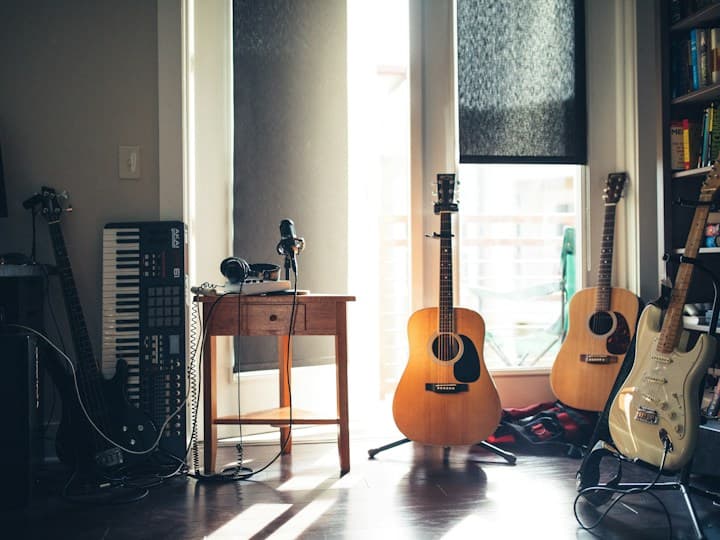 Guitars and recording equipment in a sunlit music studio